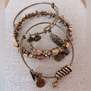 Trio of Alex & Ani bracelets | gold arm party